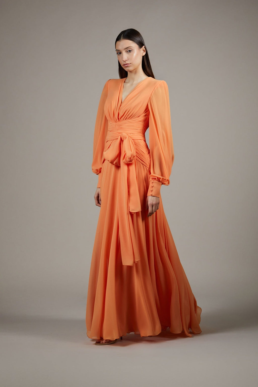 Long-sleeve pleated chiffon gown with waist bow