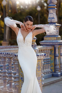 HerTrove-Elegant white gown with plunging neckline and feather details