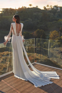 HerTrove-long column white gown with plunging neckline and feather details