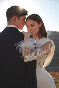 HerTrove-long column white gown with plunging neckline and feather details
