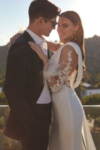 HerTrove-long column white gown with plunging neckline and feather details