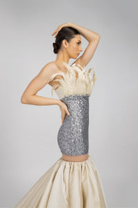 HerTrove-An evening dress made of shiny sequins and crepe, adorned with feathers and crystals.