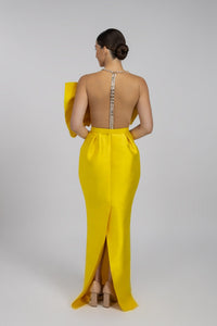 HerTrove-A long yellow taffeta evening dress with a modern design featuring a large bow and a transparent back.
